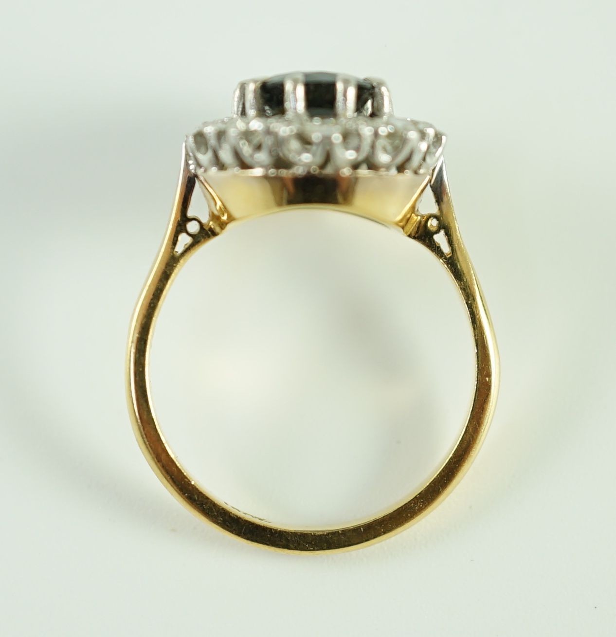 An 18ct gold, sapphire and diamond set oval cluster dress ring